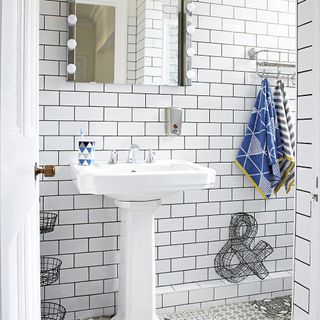 Bathroom with white tiles and black grouting