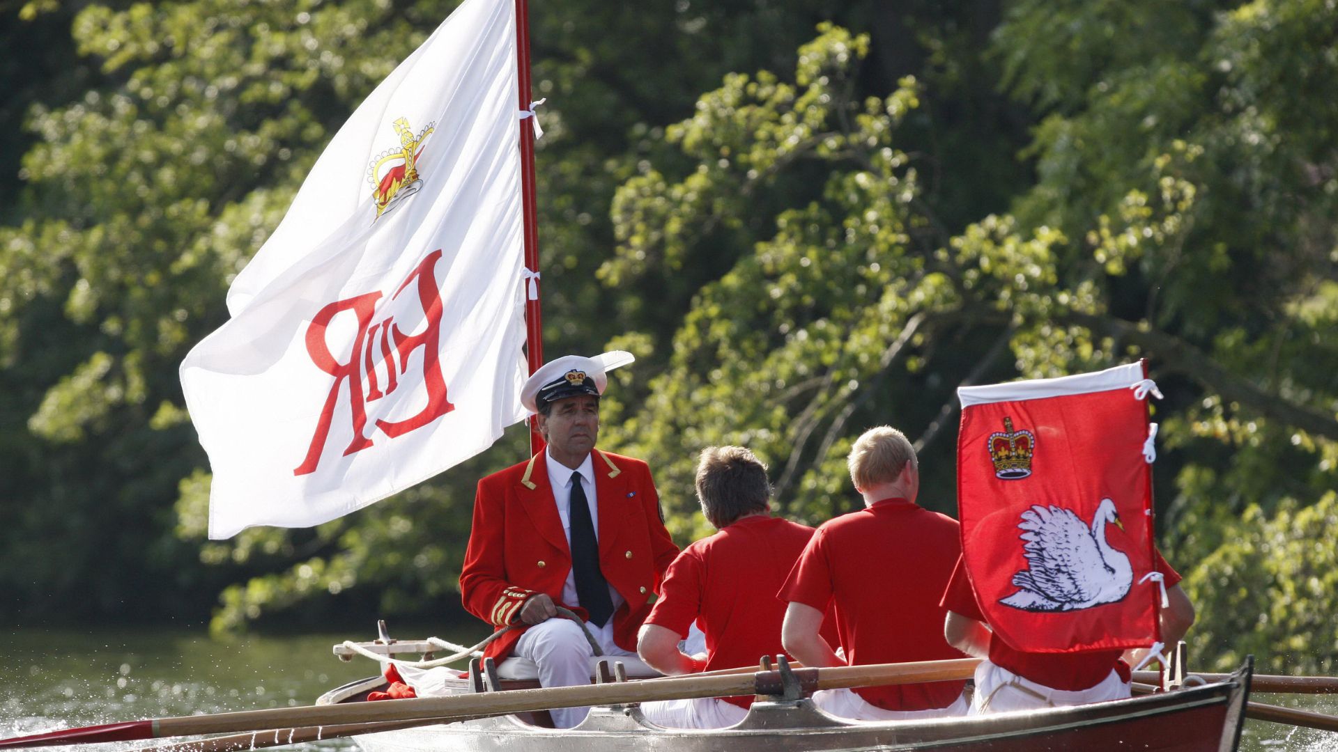 The Marker of the Swans on a boat with the Royal Standard