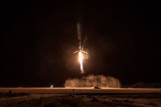 A SpaceX Falcon 9 rocket first stage approaches a touchdown at Landing Zone 1 at the Cape Canaveral Air Force Station.
