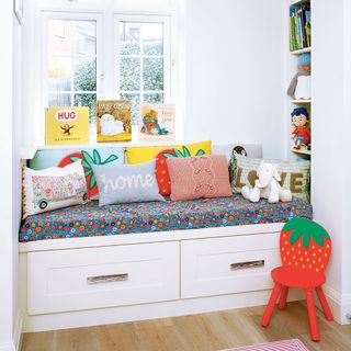 white window side seating with cartoons designed cushions