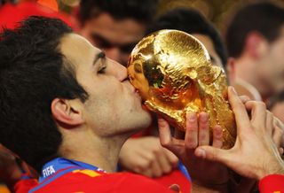 Cesc Fabregas kisses the World Cup trophy after Spain's win in 2010.
