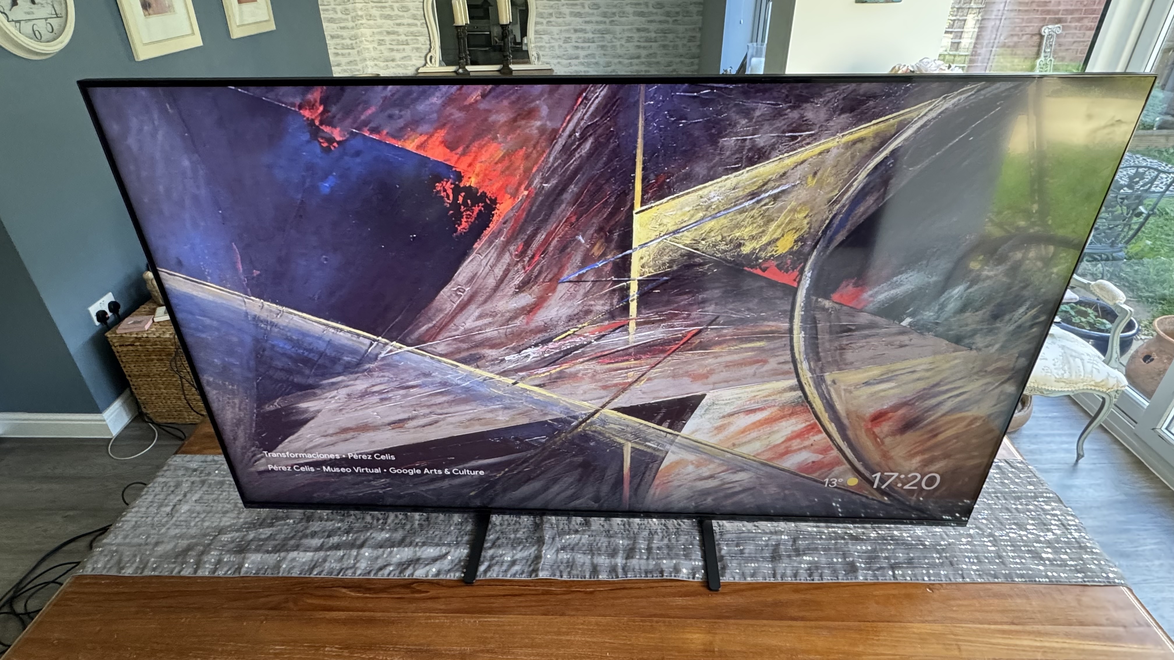A high angle of the Sony 65 Bravia 5 TV on a wooden TV cabinet