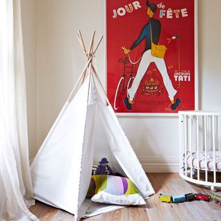 kids room with wooden flooring and toddler bed