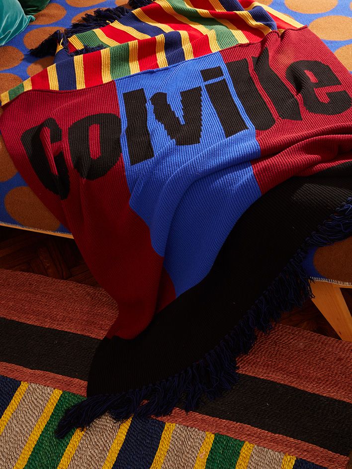 Coloured knitted throw, Colville worded across it