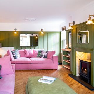 living room with wooden flooring and pink sofaset with cushions