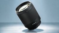 TTArtisan AF 85mm f/1.8 Neo product image on blue background 