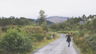 Woman walking in the Trossachs National Park