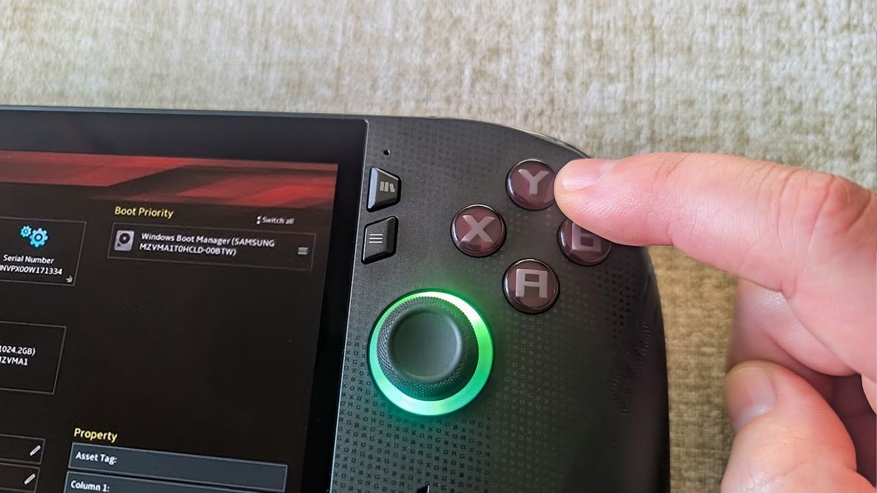 Xbox Ally X showing BIOS and a finger pushing the Y button on the handheld.