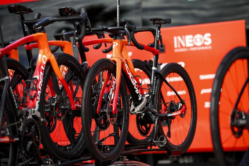 Pinarello bikes racked up in front of an Ineos bus