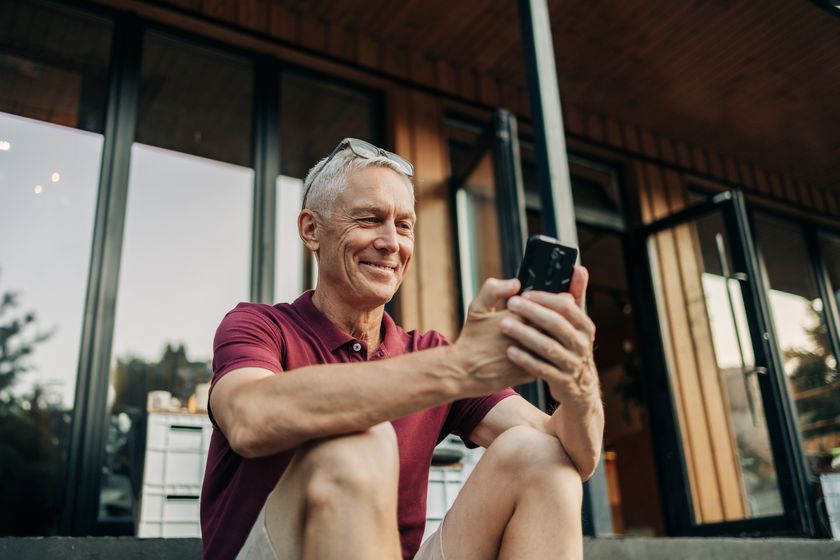 An older man checks his AI retirement plan on his phone
