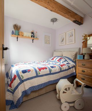 children's cottage bedroom with patchwork bed quilt and traditional wooden furniture