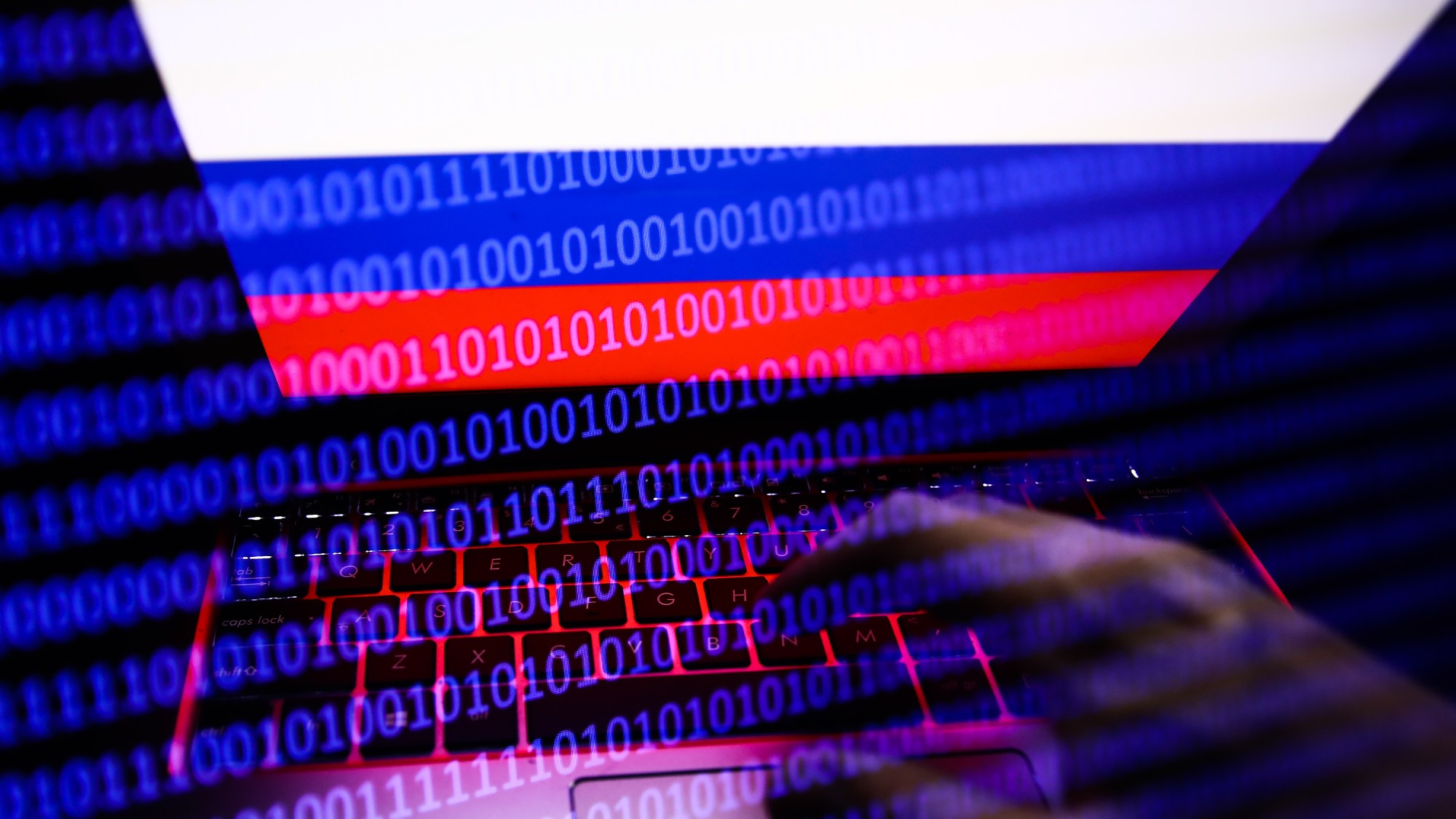 Illustration of a Russian flag, hands on keyboard, and illuminated binary code