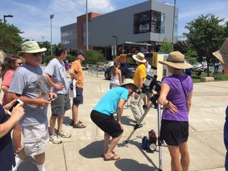 In Carbondale, Illinois, people look through a solar-viewing telescope in preparation for the total solar eclipse on Monday (Aug. 21).