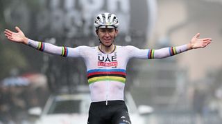 Tadej Pogacar of Slovenia and Team UAE Team Emirates celebrates as he crossing the finish line on his bike ahead of the