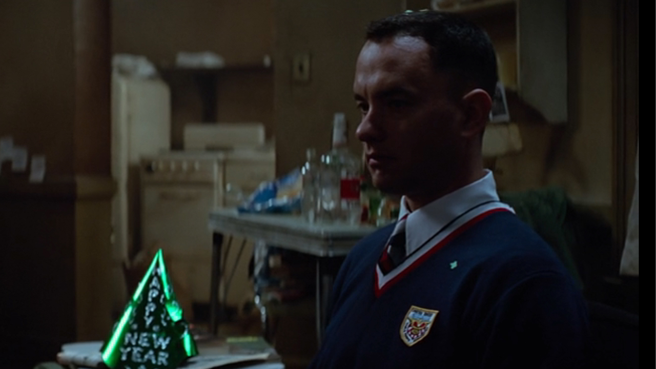 Tom Hanks in full military uniform, looking uncomfortable with a New Years Hat near him in Forrest Gump