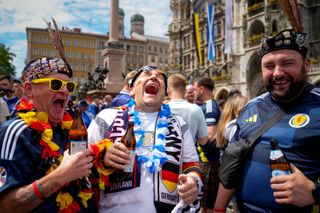 Scotland and Germany football fans drink beer and share a laugh ahead of the opening match of Euro 2024 between Germany and Scotland in Munich, Germany