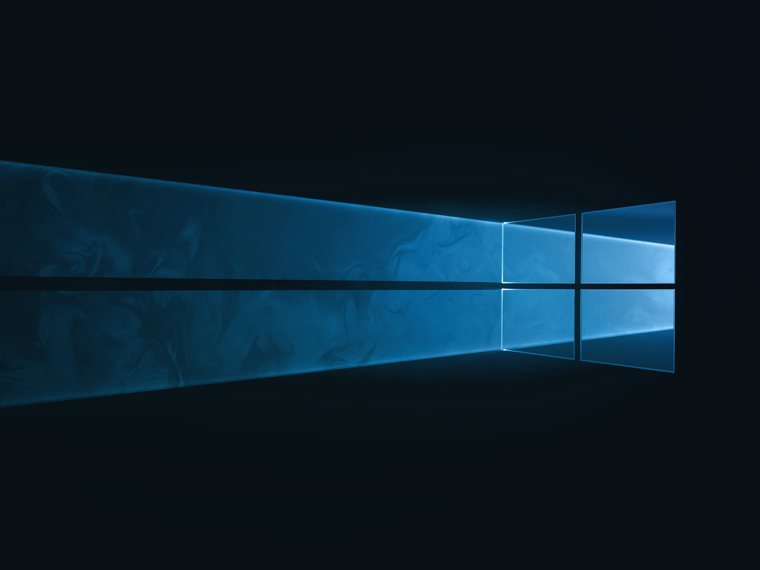 WIP versions of Windows 10 desktop background with light being filtered through a physical windows 10 logo