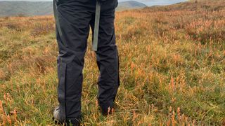 Hiker wearing Keela Rainlife 5000 waterproof trousers