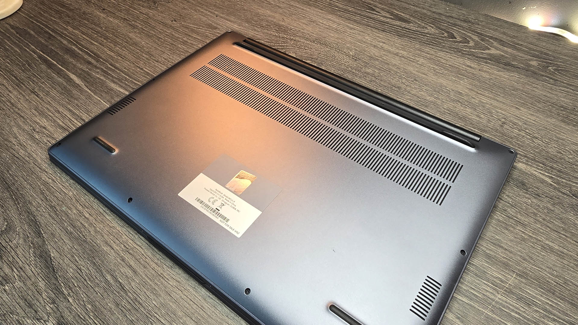 The Huawei MateBook D 16 on a wooden desk.