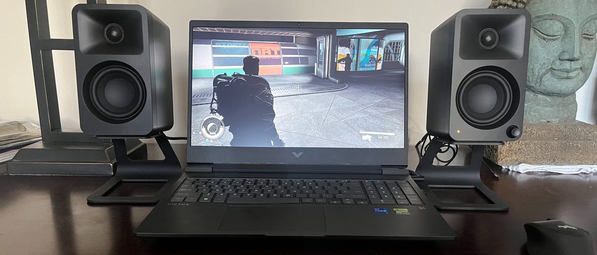 HP Victus 16 gaming laptop on a desk playing a game