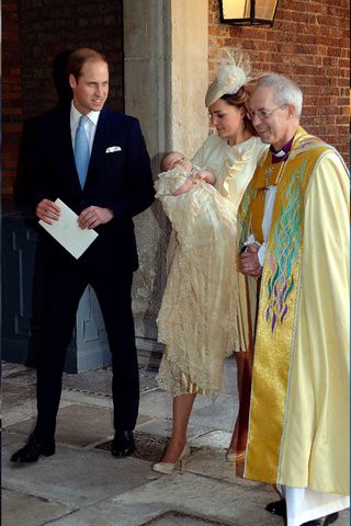 Catherine, Duchess of Cambridge carries her son Prince George Of Cambridge with Prince William
