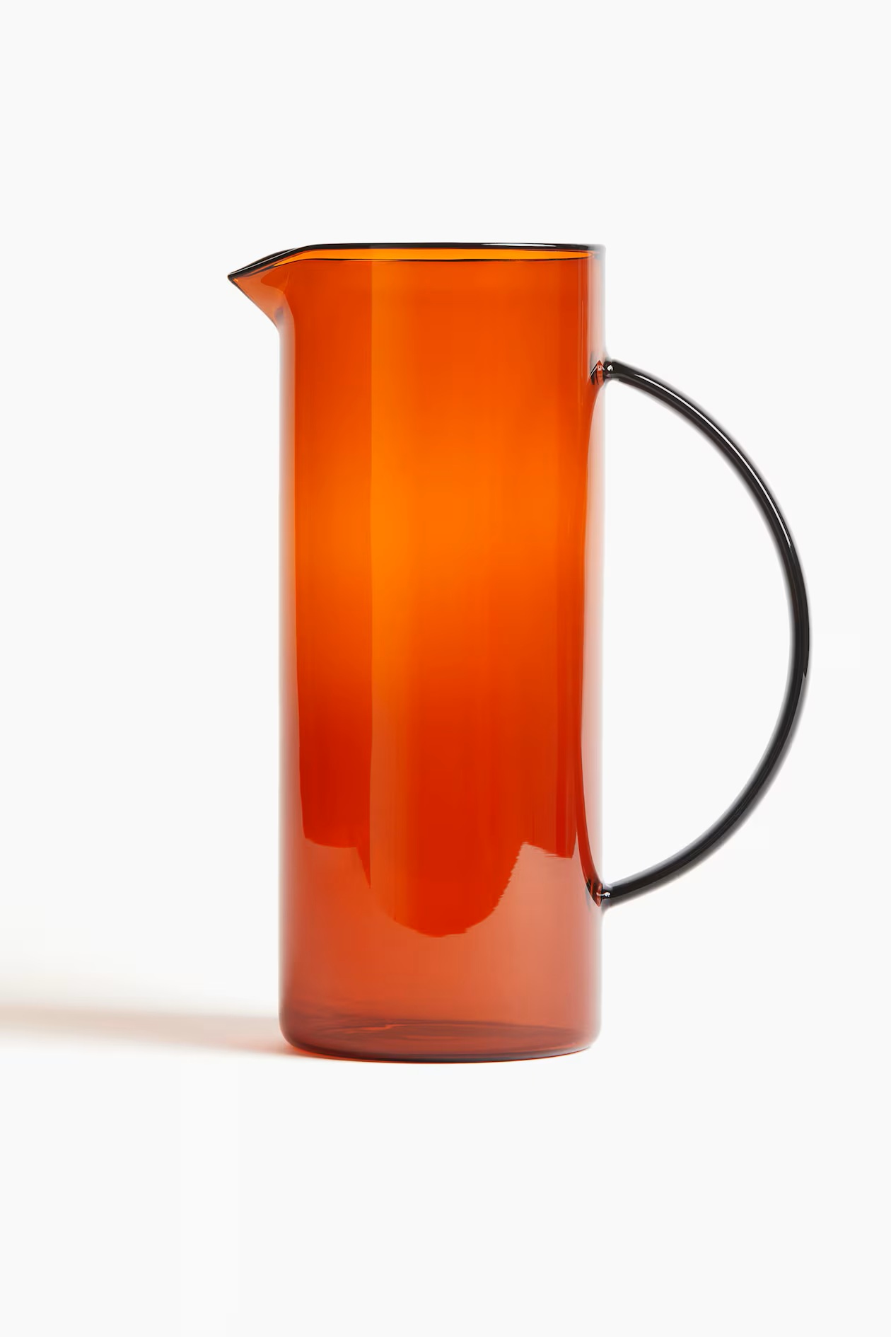A orange-shaded glass pitcher with a retro feel.