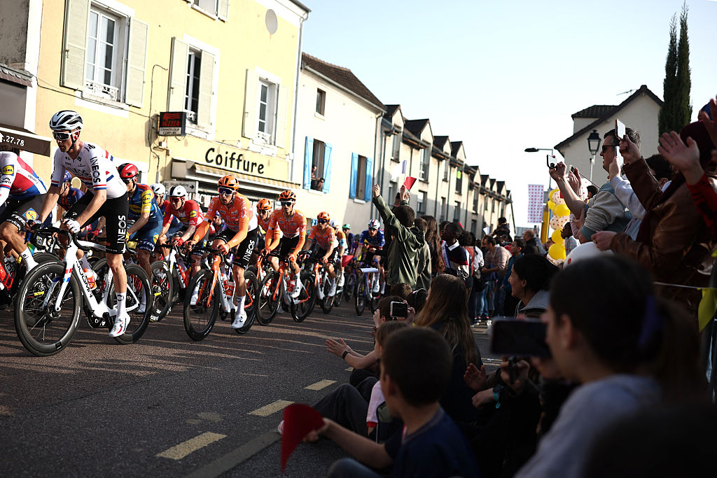Spectators wave at riders during the 1st stage of the Paris-Nice cycling race, 170.9 km between Ach&amp;egrave;res and Carri&amp;egrave;res-sous-Poissy, on March 8, 2026. (Photo by Anne-Christine POUJOULAT / AFP)