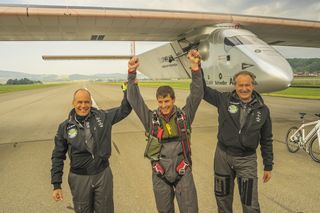 Solar Impulse co-founders Bertrand Piccard and André Borschberg congratulate test pilot Markus Scherdel after the maiden voyage of the Solar Impulse 2.