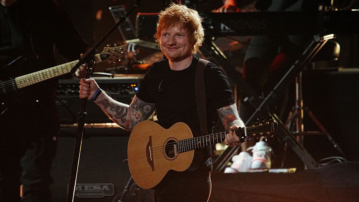 Ed Sheeran holding a guitar on stage during the 37th Annual Rock &amp; Roll Hall of Fame Induction Ceremony