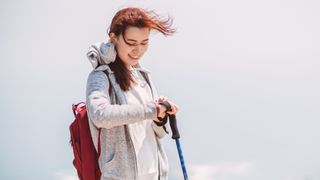 Young woman using sports watch while hiking