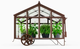 cast iron greenhouse with plants in it