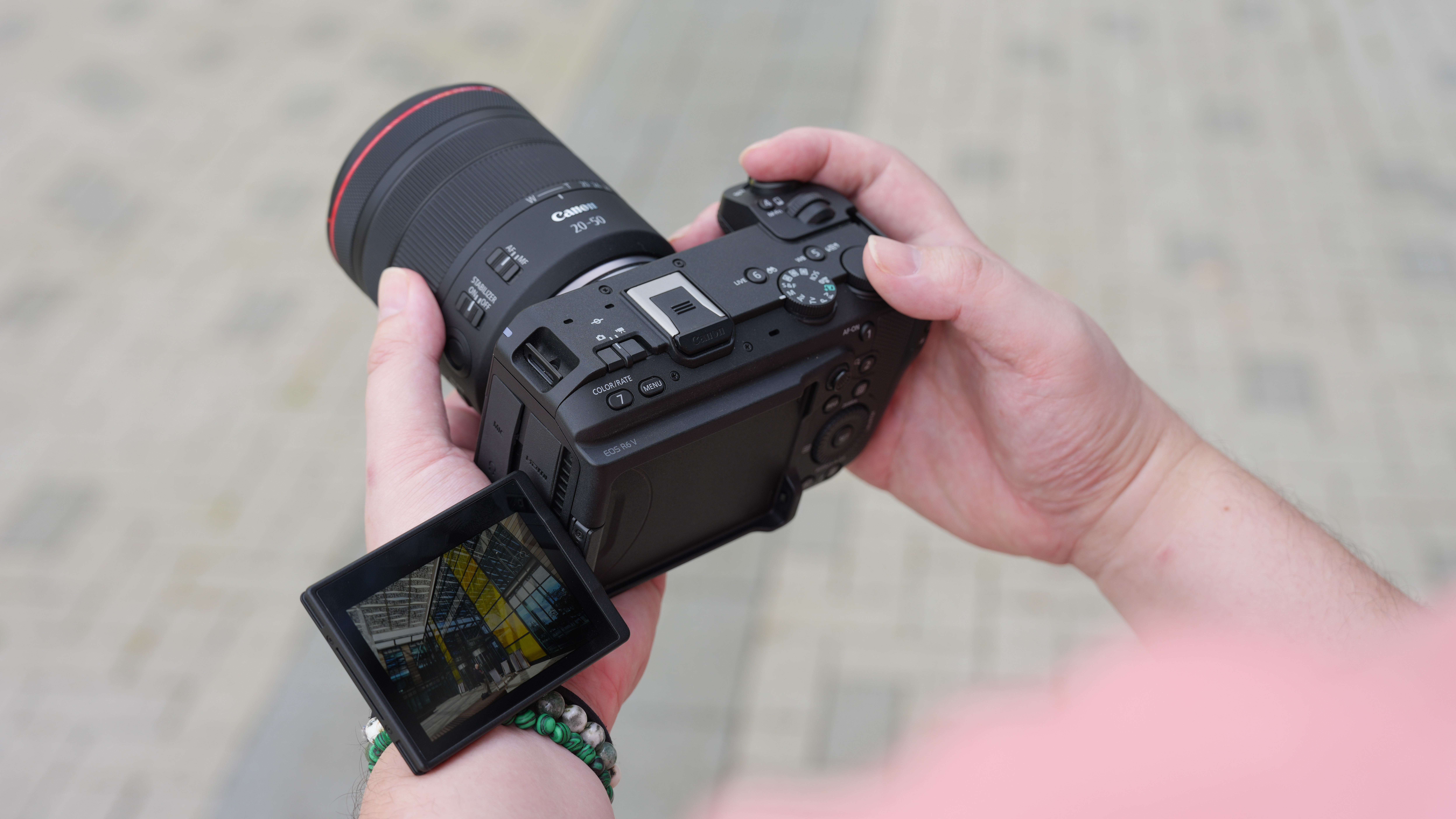 Canon EOS R6 V with the Canon RF 20-50mm f/4L IS USM PZ being held outdoors