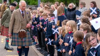King Charles III meets school children during a visit to the Discovery Centre and Auld School Close