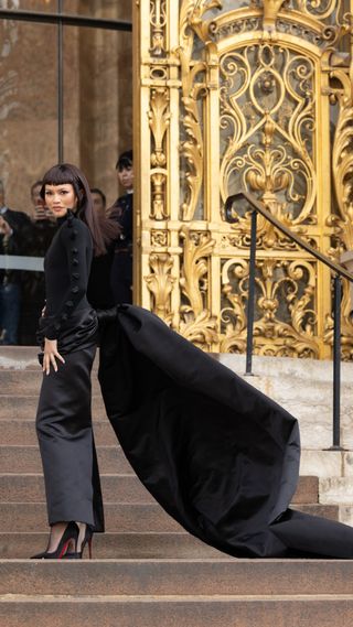 Zendaya wearing a black long sleeve dress with a long train to Schiaparelli Haute Couture show in Paris