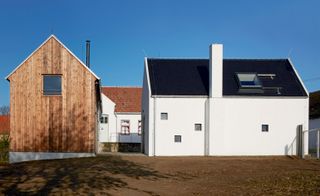 ADR’s wooden extension and new building (front right), with the farmhouse in the background