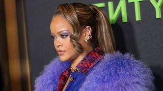 Rihanna is pictured with cool brown hair and highlights, in a long ponytail whilst attending the FENTY x PUMA sneaker launch party at NeueHouse Los Angeles on December 18, 2023 in Hollywood, California.