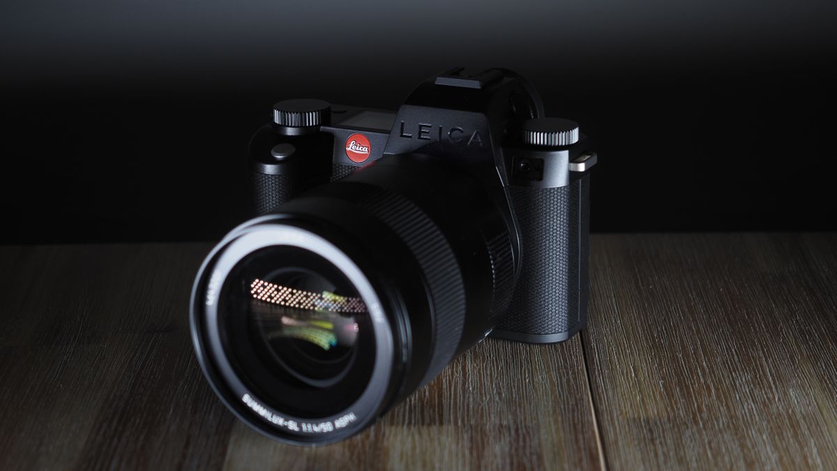 Leica SL3-S on a wooden surface with moody lighting