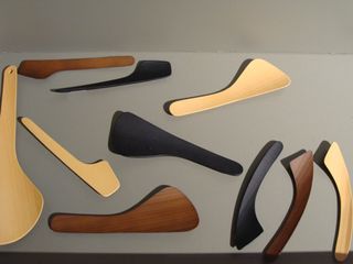 Ten spatulas of different shapes and sizes in black, brown and beige.