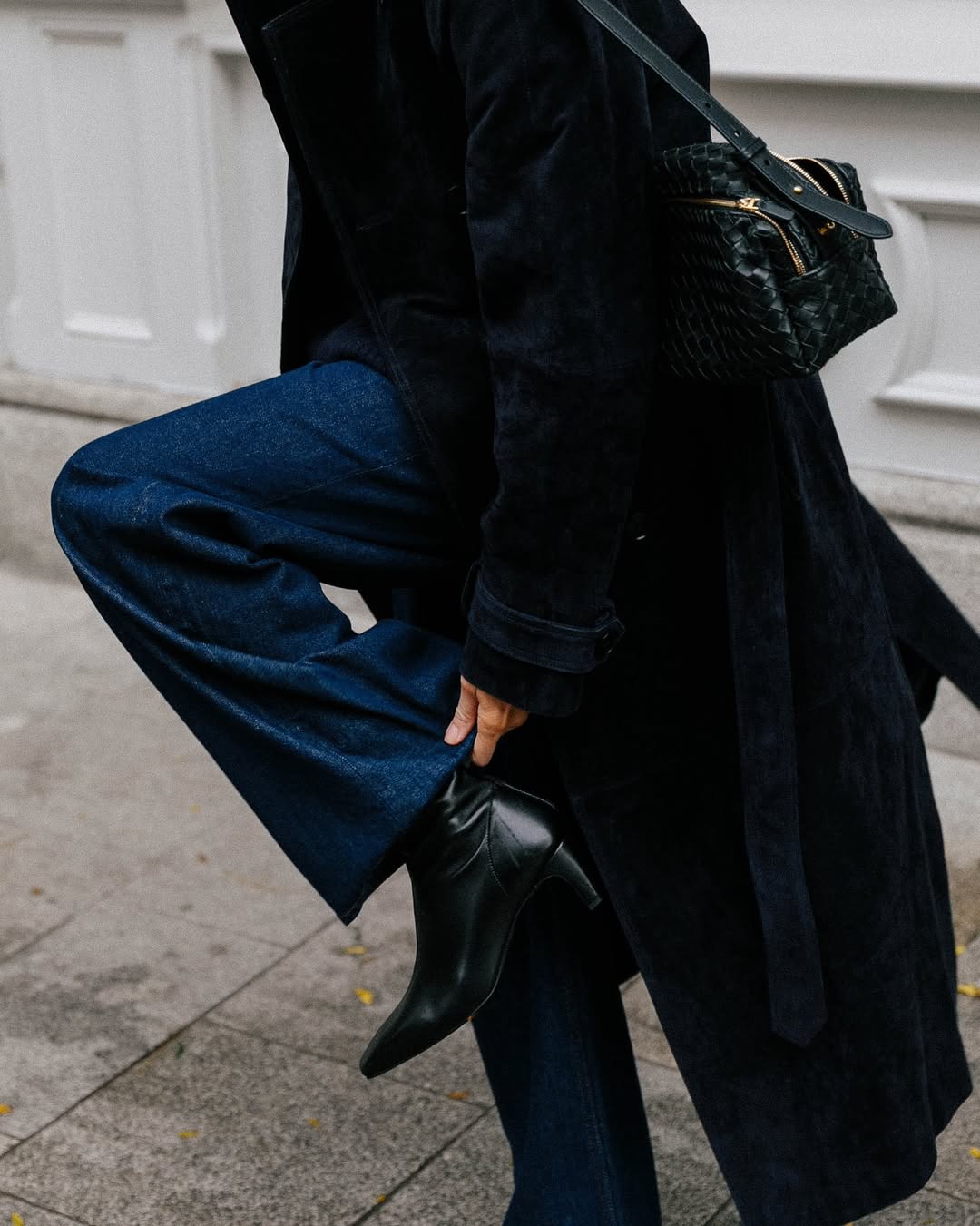 Kim wearing jeans and black boots