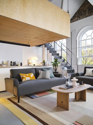 Two dark grey sofas in an open plan loft style living space