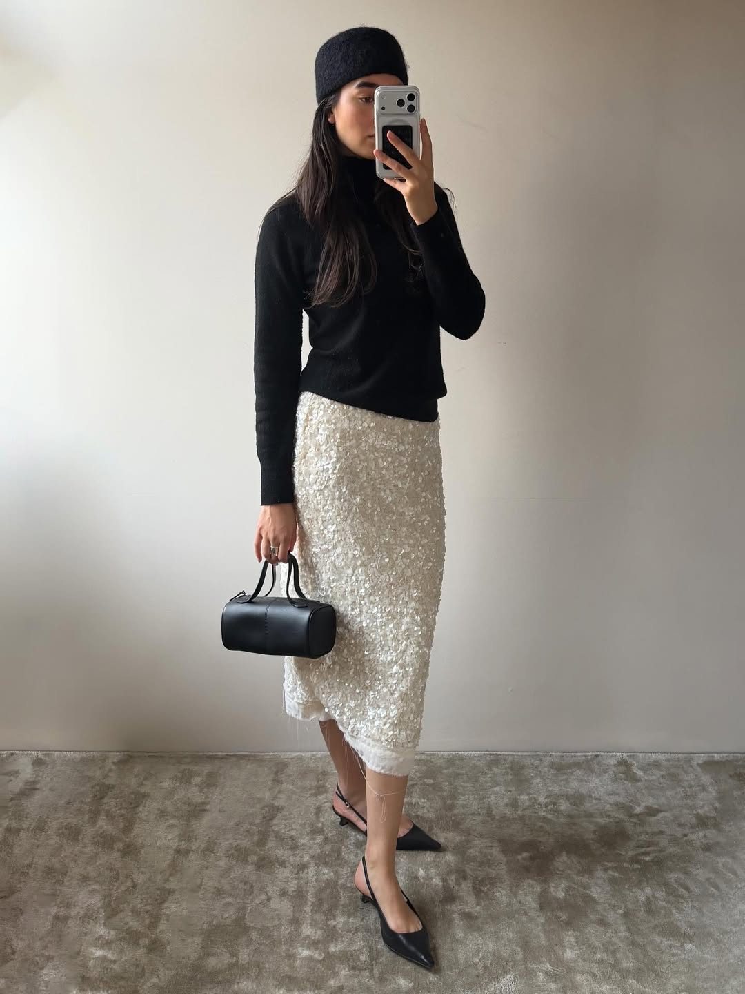 influencer wearing a turtleneck with a sequin skirt