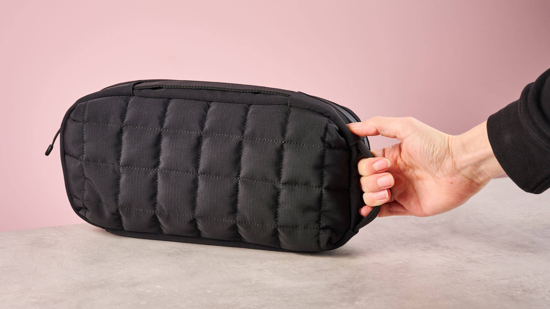 Person grabbing the Hori Puff Pouch for Nintendo Switch 2