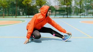 Woman stretching before going for a run, stretching leg