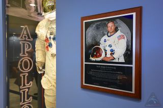 A plaque and spacesuit display have been added to the lobby of the Operations and Checkout building at NASA's Kennedy Space Center in Florida to honor the building's new namesake, Apollo 11 moonwalker Neil Armstrong.
