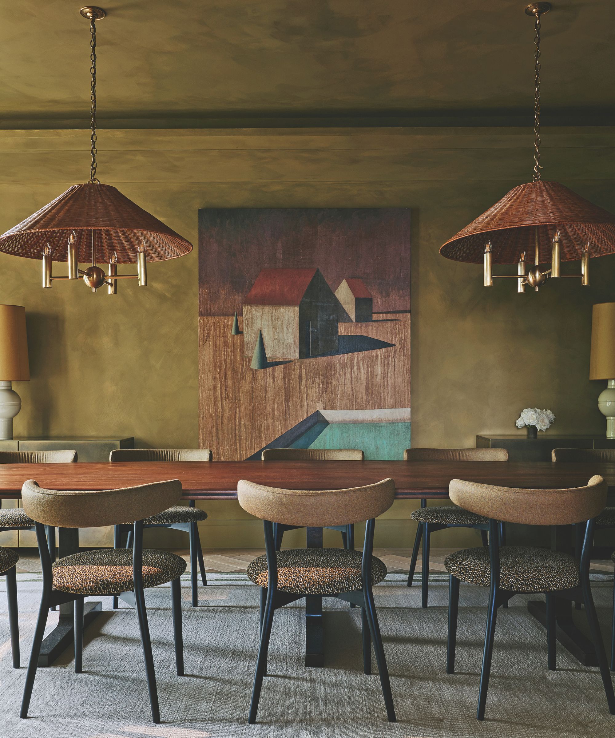 dining room with wooden table and upholstered chairs and statement rattan pendant lights