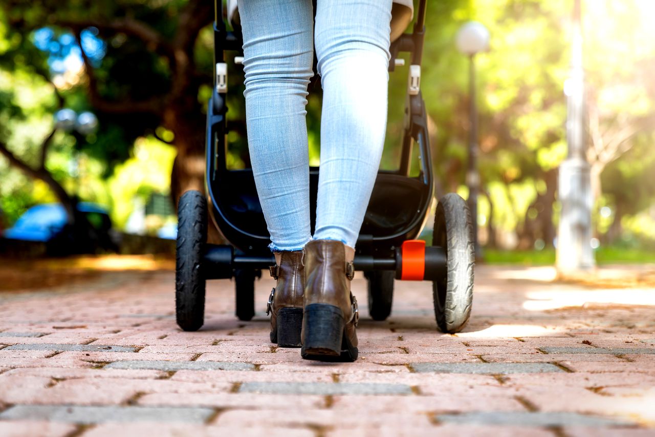 A woman pushing a stroller.