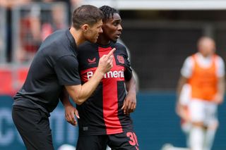 Xabi Alonso of Bayer 04 Leverkusen and Jeremie Frimpong of Bayer 04 Leverkusen talk together during the pre-season friendly match between Bayer 04 Leverkusen and West Ham United at BayArena on August 5, 2023 in Leverkusen, Germany.
