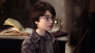 Young Harry Potter holding wand in The Sorcerer's Stone