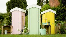 Trio of pastel sheds in pink, mint, and yellow