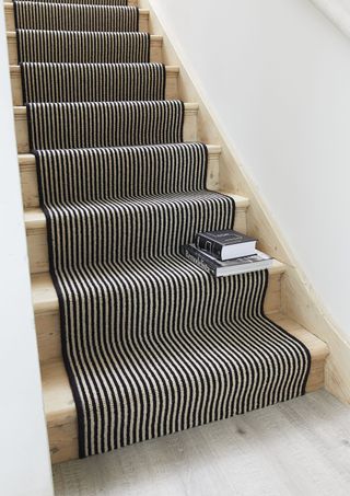striped stair runner and pine staircase with white walls